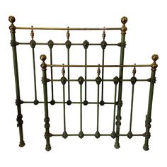 an old iron bed frame with brass knobs