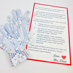 a card with some beads on it next to a pair of blue and white gloves