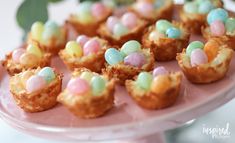 small cupcakes with colorful candy on a pink plate