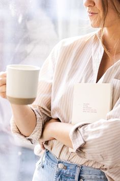 a woman holding a coffee cup in her right hand