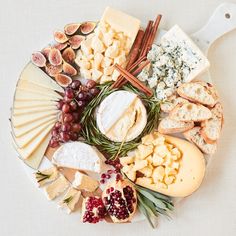 an assortment of cheeses and crackers on a platter