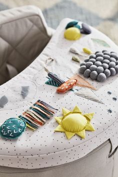 a close up of a baby's seat cushion with buttons and other things on it