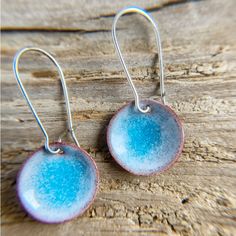 Blue enamel round water pod earrings, torch fired enameled copper inspired by the ocean and water. These aqua blue dangle earrings are perfect for you who loves the ocean, lakes and water scenes. Inspired by my paddling adventures, totally true to nature! I design and craft all my copper pieces in my studio. Enameled pieces are torch fired with lots of love and fun! Handcrafted stainless steel or sterling silver earwires. Hook wires come with rubber stoppers. Handmade in USA. * * * * * * * * * * * * * * * * * * * * * * * * * * * * * * * * * * Back to Shop: https://www.etsy.com/shop/BlueFinnStudio WHAT IS ENAMELED COPPER? Enameling is glass fused to metal at high heat. Enamels are finely ground glass, like fine sand (or even more finely pulverized and mixed with an oil or adhesive). They ma Artisan Round Enamel Jewelry, Blue Round Copper Jewelry, Gold Round Enamel Earrings, Blue Hypoallergenic Copper Earrings, Blue Enamel Jewelry With Polished Finish, Blue Copper Round Jewelry, Blue Enamel Earrings With Artistic Design, Copper Enameling, Blue Enamel Earrings