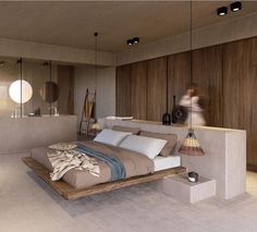 a large bed sitting inside of a bedroom on top of a hard wood flooring