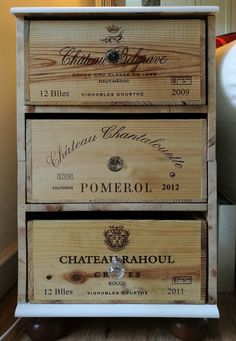 three wooden drawers with wine labels on them