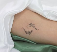 a woman's leg with a horse and fish tattoo on her left side ribcage