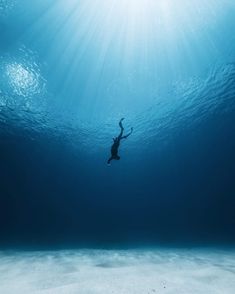 a person swimming in the ocean under water