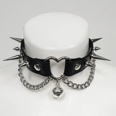 Spiked leather choker is made of 100% Italian leather, high quality. The parts of the choker are hand cut and assembled by me. There is a heart in the center, which is a great detail and gives this choker a special look. It softens the sharpness of the spikes but so that the choker still looks wicked. Fastens with a roller buckle on the back of the neck. Super cute details are chains and a and a kitty bell. Be modern, be yourself. It doesn't matter if you like the classic gothic look, grunge got Emo Choker, Human Collar, Alt Choker, Choker With Bell, Chokers Black, Gothic Chokers Collars, Heart Choker Collars, Cute Chokers, Aesthetic Choker