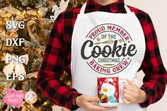 a person wearing an apron and holding a mug with the words proud member of the cookie baking crew