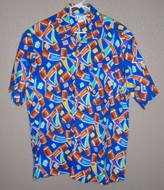 Mac Duds "Mad About Cooking" Short Sleeve Collared, Button Front Shirt Men's size LARGE MULTI-COLOR FOOTBALL GRAPHICS Excellent Preowned Condition From a Smoke Free Home THANKS FOR SHOPPING WITH IAMPARRENT! Multicolor Graphic Print Button-up Tops, Retro Multicolor Print Button-up Shirt, Vintage Multicolor Button-up Shirt, Multicolor Vibrant Print Button-up Shirt, Multicolor Vintage Print Button-up Top, Football Graphics, Button Front Shirt, Collar Shirt, Collar Shirts