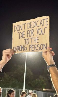 someone holding up a sign that says don't dedicate die for you to the wrong person