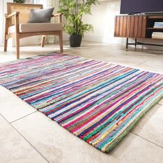 a multicolored rug in the middle of a living room