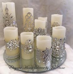 there are many candles that have been decorated with jewels and pearls on them, all in different sizes