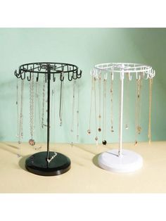 a jewelry stand with several necklaces hanging from it's sides and a round metal holder on top