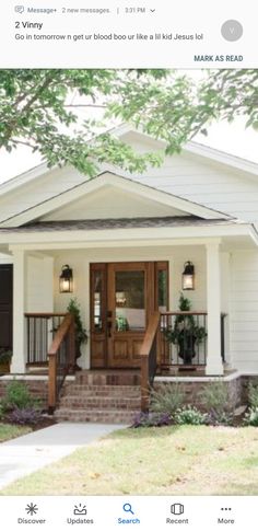 a white house with two front porches and steps leading up to the entry door