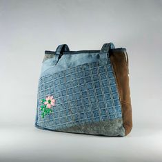 hand embroidered flower tote bag, floral tote bag aesthetic, shoulder bag for women and girls ,upcycled denim handbag ,weekender tote bag - only one of a kind, hand embroidered handmade blue jeans, patchworked denim  shoulder bag  - extremely durable and smooth zipper - very roomy can carry lots of things and still keeping its cute and elegant look from outside. with two large inner pockets ; one of them is zippered to keep your most used items easily reachable - two hidden front pockets and thr Blue Recycled Denim Bags, Daily Use Denim Blue Recycled Denim Bag, Upcycled Denim Travel Bag, Denim Travel Bag With Upcycled Material, Eco-friendly Upcycled Bags For Daily Use, Upcycled Shoulder Bag For Daily Use, Upcycled Recycled Denim Shoulder Bag For Everyday, Eco-friendly Rectangular Denim Bag, Handmade Rectangular Recycled Denim Bag