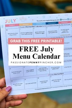 a hand holding up a free july menu calendar with the text grab this free printable