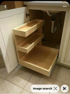 an open cabinet in the middle of a kitchen