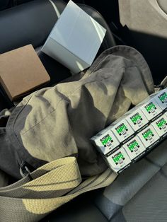 there are four batteries in the back seat of a car with other items on it