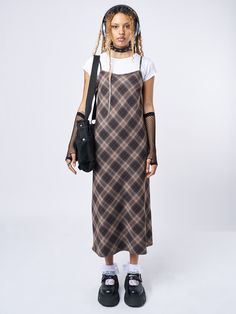 Shop our edit of trending y2k, dark academia, and grunge-inspired fashion staples like our Delia Brown Plaid Maxi Dress in brown with a check plaid pattern. Perfect for layering and ethically made to last. International shipping available. Tshirt Under Dress Outfit, Tshirt Under Dress, Dark Maxi Dress, 1990s Fashion Grunge, Y2k Dark Academia, Japanese Inspired Fashion, Layering Outfits Fall, Plaid Maxi Dress, Dress Layering