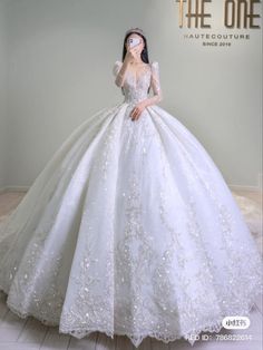 a woman in a white wedding dress is posing for the camera with her hand on her face