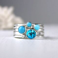 Blue turquoise and silver stacking rings. Created from four different sizes and shades of blue. The largest stone is 6mm in diameter. The other three are complimentary shades of blue and a single silver dot ring. Artfully simple if worn one at a time, they can also be worn with your other stacking rings for a pop of color. Please choose your preferred stone combination from the menu. The last Picture shows the stone combinations I have in stock.  Bright satin finish. Also available in oxidized finish (example shown in the 2nd to last picture). If you'd like your rings oxidized, leave me a note when you check out. Details: 1 - 6mm turquoise cabochon with matrix, 2.2mm hammered silver band; 1 - 5mm turquoise cabochon, 1.7mm band; 1 - 4mm turquoise cabochon, 1.7mm band; 1 - 3mm turquoise cabo Stackable Turquoise Round Jewelry, Turquoise Gemstone Stackable Rings In Sterling Silver, Bohemian Stackable Blue Turquoise Ring, Bohemian Blue Stackable Turquoise Ring, Blue Turquoise Stackable Round Ring, Unique Turquoise Stackable Jewelry, Turquoise Gemstone Stackable Rings, Unique Stackable Turquoise Jewelry, Turquoise Stackable Rings For Gifts