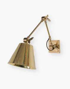 an antique brass wall light with a single arm and one bulb on the side, against a white background