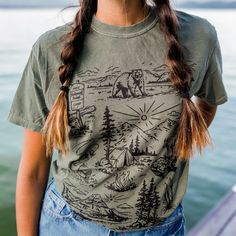 Our newest design for spring! We are so ready to explore the national forests this summer!! Unisex tee - model is wearing a medium Body Length 28 29 30 31 32 Chest Width (Laid Flat) 18 20 22 24 26 A Montana Scene Original Design. Printed in Montana. All designs are property of The Montana Scene. All rights reserved. All of The Montana Scene apparel is designed and printed locally in Montana. Come visit our storefront locations! Bigfork * Whitefish * Missoula * Kalispell * Bozeman Summer Outdoor Cotton T-shirt, Green Graphic Print T-shirt For Camping, Casual T-shirt For Outdoor Spring Activities, Casual T-shirt For Spring Outdoor Activities, Casual T-shirt For Outdoor Spring Events, Casual Relaxed Fit T-shirt For Outdoor Activities, Screen Print T-shirt For Summer Outdoor, Green Graphic Tee For Outdoor, Summer Outdoor Screen Print T-shirt