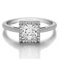 a white gold ring with a princess cut diamond in the center