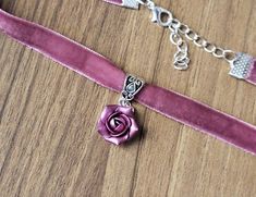 "Pink-purple velvet ribbon choker with sculpted handmade rose. Material of flower is polymer clay with special pearl cover. Each petal of flower made by hand Dia flower about 15 mm/ 0.55 \" Length of necklace is adjustable:  10-12 inches/ 25,4 - 30,5 cm 11-13 inches/ 28-33 cm 12-14 inches/ 30.5- 35.5 cm 13-15 inches/ 33-38 cm 14-16 inches/ 35.5 cm-40.5 cm 15-17 inches/ 38,1 cm- 43,2 cm 16-18 inches/ 40.6 cm- 45.7 cm 17-19 inches/ 43 cm - 48 cm 18-20 inches/ 45,5- 50.8 cm Width of ribbon 10 mm / 0.4 inch If you need other length of necklace let me know and I will make it for you. Polymer clay isn't afraid of water, strong and non-toxic. Gorgeous gift for women and girls as handmade item ALL CHOKERS - https://www.etsy.com/shop/BuduartJewelry?ref=simple-shop-header-name&listing_id=694544029§i Polymer Clay Cute, Purple Flower Necklace, Clay Cute, Navy Blue Earrings, Rose Choker, Ribbon Choker, Rose Violette, Handmade Rose, Choker Pendant