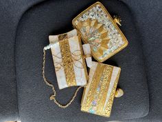 "Introducing our stunning brass clutch in a striking golden color.  It is adorned with a mother of pearls featuring intricate handwork. This statement piece boasts a beautiful stone knob and comes with lining, pocket slip, and a high-quality chain with pearls. Keep it safe with the included complementary dust bag. It's the perfect size for all your essentials. Champagne Frost Clutch Size- 6.5\" by 4\" Opal Shores Clutch and Golden Snowdrift Clutch Size- 6.5\" by 5\"" Gold Embroidered Clutch For Wedding, Gold Rectangular Evening Bag For Festivals, Traditional Gold Clutch With Gold Embroidery, Traditional Gold Evening Bag With Gold Embroidery, Traditional Gold Clutch For Wedding, Gold Rectangular Clutch For Festivals, Handmade Gold Clutch For Festivals, Gold Embroidered Evening Bag Gift, Gold Clutch With Gold Embroidery For Formal Occasions