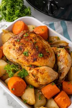 a roasting pan with chicken, potatoes and carrots on the table next to an instant pressure cooker