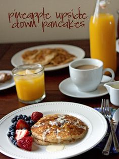 someone is pouring syrup on some pancakes and fruit to make them look like they are going to eat