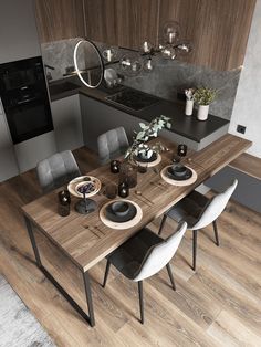 a dining room table with chairs and plates on it