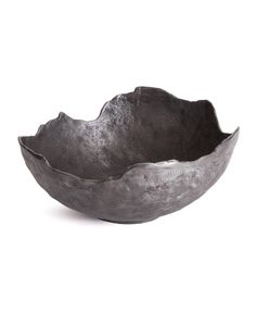 a metal bowl sitting on top of a white table