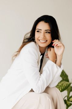 a woman sitting on top of a chair smiling