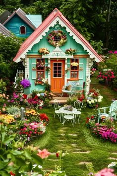 a small house with flowers and chairs around it