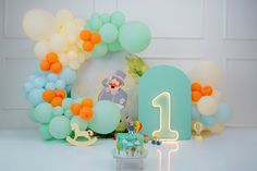 a birthday party with balloons, cake and decorations