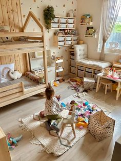 a child playing with toys in a room full of wooden bunk beds and other children's furniture