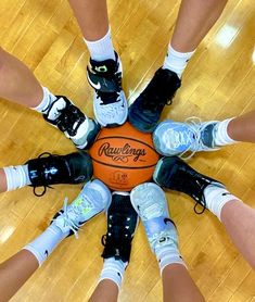 a group of people standing around a basketball