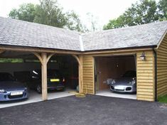 two cars are parked in the garage next to each other and one is black car