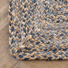 a blue and beige area rug on top of a wooden floor