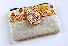 a small purse with an orange bow on the front and yellow polka dots on the back