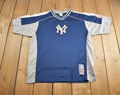 a baseball jersey laying on top of a wooden floor