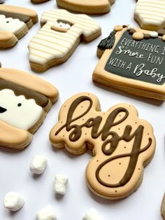 baby cookies are arranged on a table with marshmallows