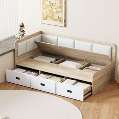 a bed with drawers underneath it in a room