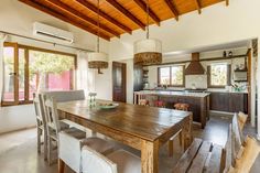 a wooden table sitting in the middle of a kitchen