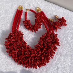 Unique and elegant high quality hand made bead jewelry in styles. 3 layers bead jewelry, red beads, medium size jewelry, fit all size. The color can be customized to suit customer's preference but in this case there will be a waiting period to make them ready for shipping. The length of the necklace is 18.5inches, the bracelet is about 8.5inches and earring is about 2.5inches. We have varieties of beads for formal and casual outfit, contact us today for all your hand made beads. Red Beaded Bracelets With Round Beads For Wedding, Red Round Beaded Bracelets For Wedding, Red Beaded Necklaces For Wedding With Round Beads, Red Large Beads For Wedding, Red Polished Beads Jewelry Sets, Red Jewelry Sets With Polished Round Beads, Red Beaded Necklace For Wedding, Red Coral Beaded Necklaces For Wedding, Handmade Red Beads For Wedding