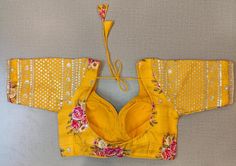 Beautiful yellow floral choli-cut saree blouse with embroidered sleeves. Buy designer blouse in USA from Pure Elegance. Disclaimer: The actual product may vary slightly from the image. These are custom orders, hence expect slight variation in color, placement of the motif or buta. ESTIMATED DELIVERYBecause this is a custom order, it would take about 4 weeks from the date of purchase. RETURN POLICY: This product is a custom order and cannot be returned or exchanged. Designer Sari, Saree Blouses Online, Indian Clothing Store, Blouse Designer, Saree Style, Embroidered Saree, Embroidered Sleeves, Saree Blouses, Pure Elegance