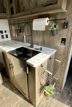 a kitchen with a sink, dishwasher and towel rack